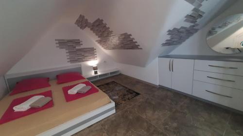 a bedroom with a bed with red pillows and a mirror at Guesthouse Next to beach in Batumi