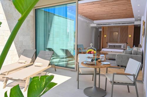 a living room with a table and chairs at Acapulco Resort Hotel in Kérynia