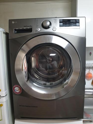 a silver washing machine sitting in a kitchen at Cheongryangri Zebra Cinema & Rooftop in Seoul
