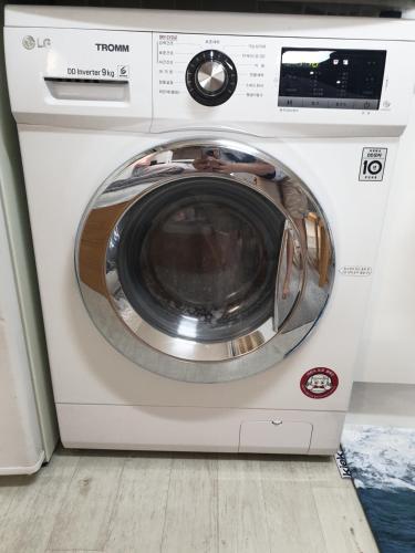 a washing machine is sitting in a room at Cheongryangri Zebra Cinema & Rooftop in Seoul