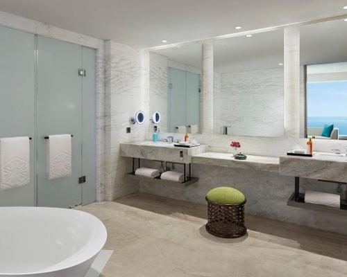a bathroom with two sinks and a large mirror at Taj Cidade de Goa Horizon, Goa in Panaji