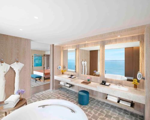 a bathroom with two sinks and a large mirror at Taj Cidade de Goa Horizon, Goa in Panaji