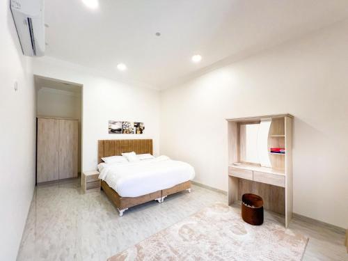 a white bedroom with a bed and a window at AL Rabie Resort ,Nizwa Grand Mall in Firq