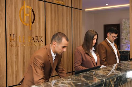 a group of three people standing around a table at Hill Park Gusar in Qusar