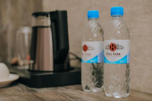 two bottles of water sitting on top of a counter at Hill Park Gusar in Qusar
