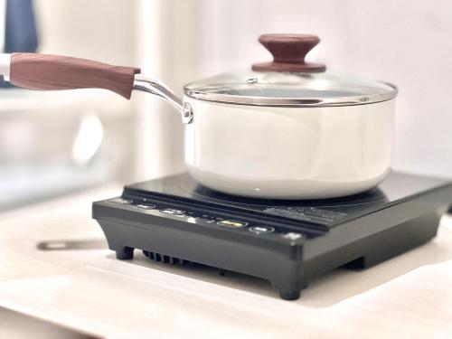 a pot sitting on top of a stove at ANX Hostel in Tokyo