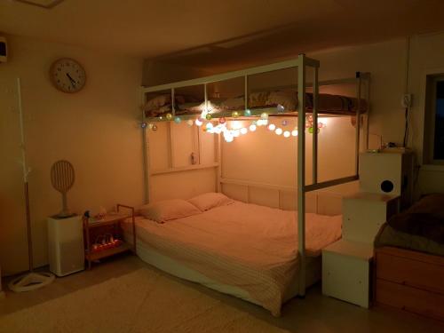 a bedroom with a bunk bed with lights on it at Cheongryangri Zebra Cinema & Rooftop in Seoul
