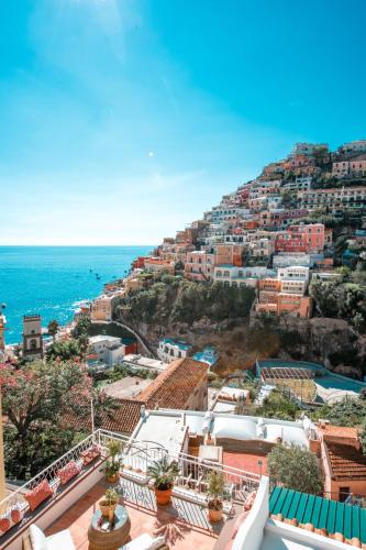 a view of a town on a hill with the ocean at Hotel Punta Regina in Positano