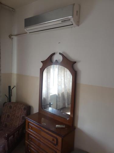 a mirror on top of a dresser in a room at Alotaibi building # 6 in Amman