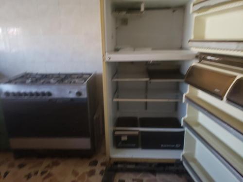 an empty refrigerator with its door open in a room at Alotaibi building # 6 in Amman