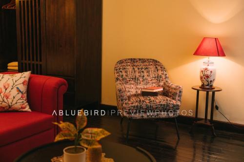a living room with a chair and a lamp at High-class French villa 168m2 by SSens Homes in Hanoi