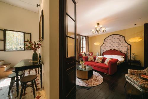 a living room with a red couch and a table at High-class French villa 168m2 by SSens Homes in Hanoi