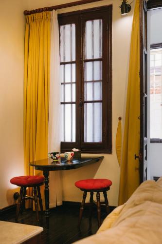 a room with a table and two stools and a window at High-class French villa 168m2 by SSens Homes in Hanoi