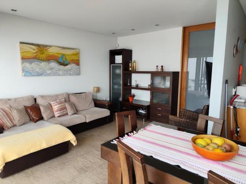 a living room with a table and a couch at Perfect Sea View in Vila do Conde