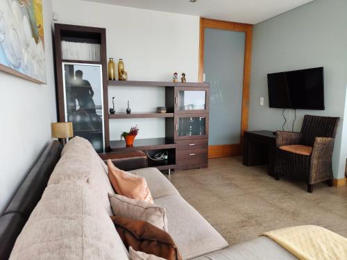 a living room with a couch and a tv at Perfect Sea View in Vila do Conde