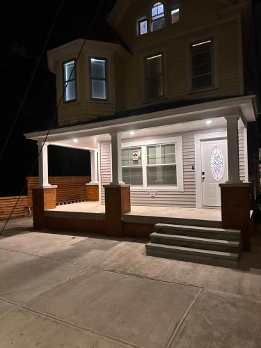a house with a front porch with a white door at 4 bed Luxury house in Schenectady