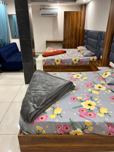 a room with two beds with flowers on them at Divya Hotel in Rishīkesh