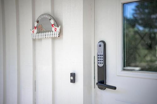 a door with a thermometer next to a window at Sea-loving house in Åhus