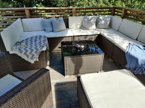 a patio with a couch and a table and chairs at Sea-loving house in Åhus