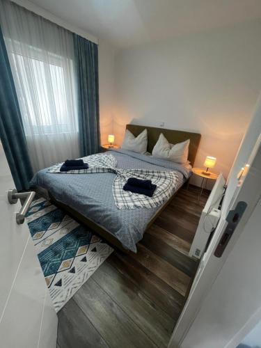 a bedroom with a bed with two shoes on it at Apartment Aleja in Sarajevo