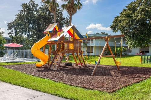 a playground with a slide in a park at Baymont by Wyndham Orlando Lake Buena Vista South in Kissimmee