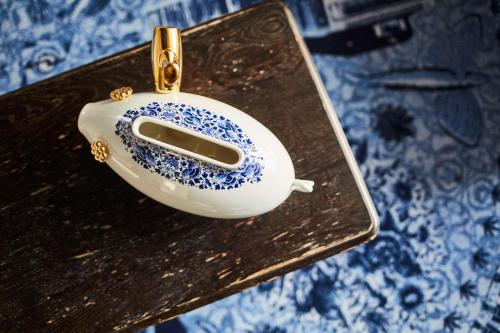 a pendant of a blue and white object on a table at Andaz Amsterdam, Prinsengracht, By Hyatt in Amsterdam