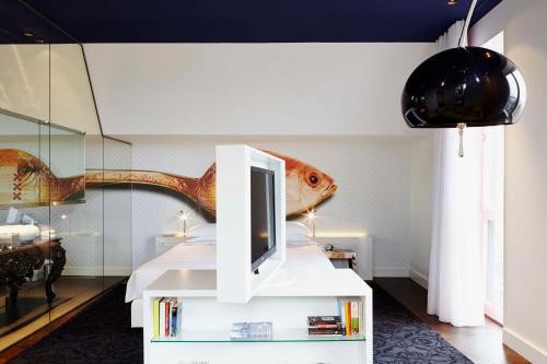 a bedroom with a bed with a fish head on the wall at Andaz Amsterdam, Prinsengracht, By Hyatt in Amsterdam