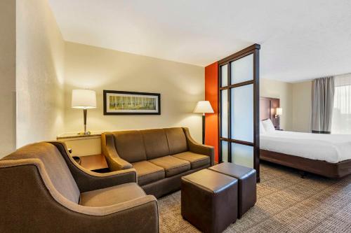 a hotel room with a couch and a bed at Comfort Suites East Lincoln - Mall Area in Lincoln