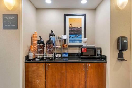 a kitchen with a counter with a microwave on it at Comfort Suites East Lincoln - Mall Area in Lincoln