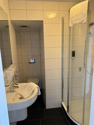 a bathroom with a sink and a shower at Hotel SchlossStuben in Nordkirchen