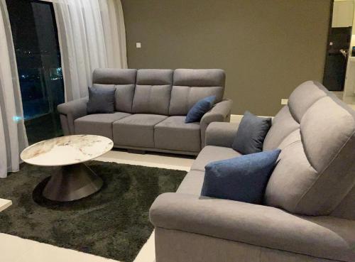 a living room with a couch and a table at Suasana Suites Johor Bahru City Centre in Johor Bahru