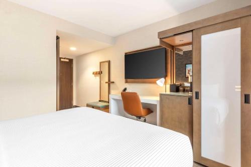 a hotel room with a bed and a desk at Cambria Hotel Denver Downtown RiNo in Denver