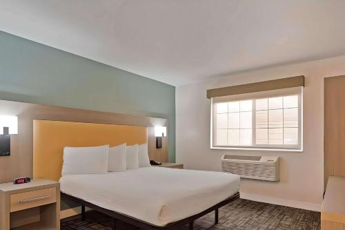 a bedroom with a large bed and a window at Comfort Inn Hayward - Union City in Hayward