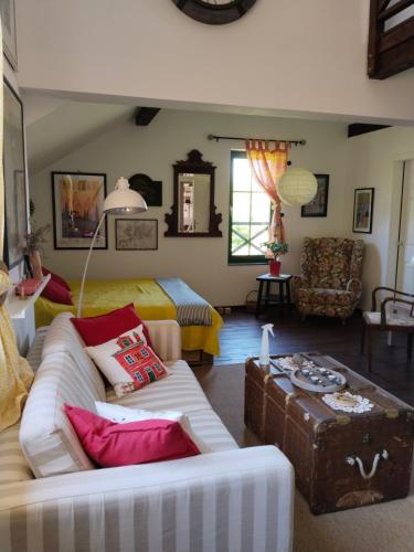 a living room with a couch and a bed at Guesthouse Silvani in Kruševac