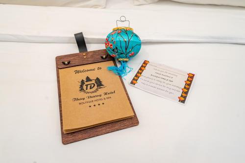 a medal on a table with a sign on it at ANNAM HERITAGE - Thuy Duong 3 in Hoi An
