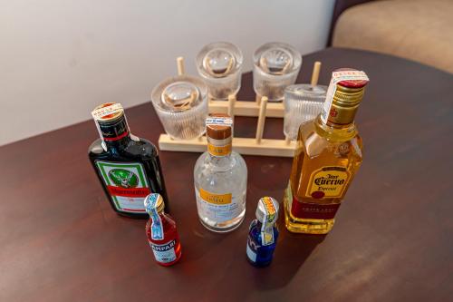 a table with two bottles of alcohol and a tray with cups at ANNAM HERITAGE - Thuy Duong 3 in Hoi An