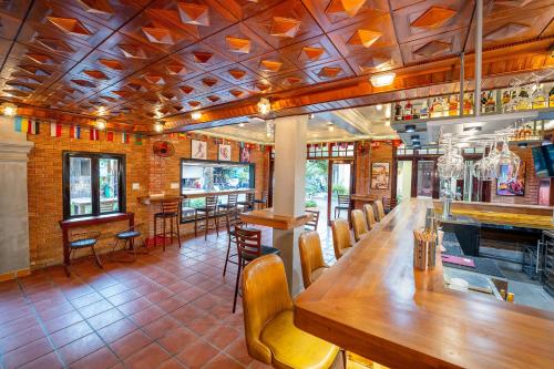 a restaurant with a long wooden table and chairs at ANNAM HERITAGE - Thuy Duong 3 in Hoi An