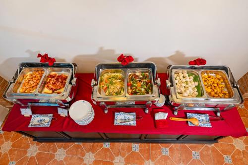 a table with three trays of food on it at ANNAM HERITAGE - Thuy Duong 3 in Hoi An