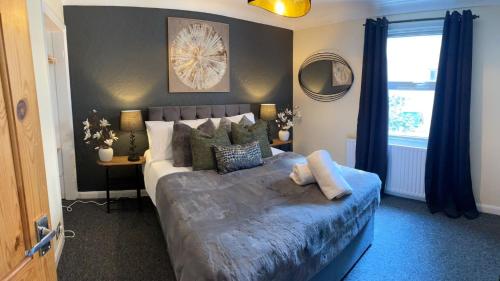 a bedroom with a large bed and a window at Prettide Suite Two-1 free Parking in Gillingham