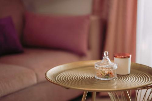 a table with a glass container and a cup on it at Blue Lagoon Villa in Stavros