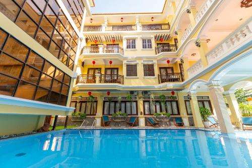 an indoor pool in a hotel with a building at ANNAM HERITAGE - Thuy Duong 3 in Hoi An