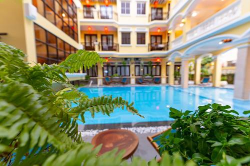a large swimming pool in a building with plants at ANNAM HERITAGE - Thuy Duong 3 in Hoi An