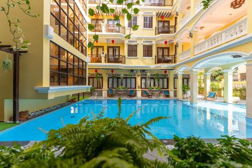 an indoor pool in a hotel with a large building at ANNAM HERITAGE - Thuy Duong 3 in Hoi An