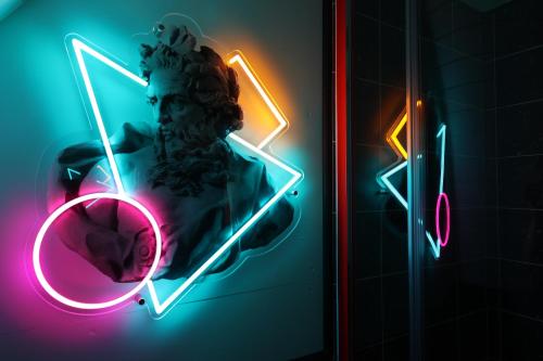 a neon sign with a statue of a man at Ammonite Glamping Pod & Hot Tub in Hungerton