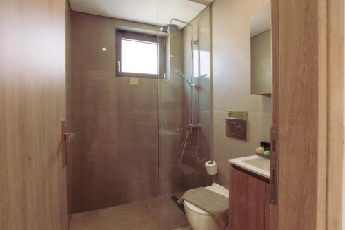 a bathroom with a shower and a toilet and a sink at Blue Lagoon Villa in Stavros