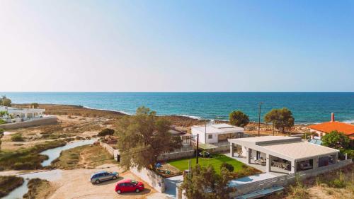 an aerial view of a house next to the ocean at Blue Lagoon Villa in Stavros