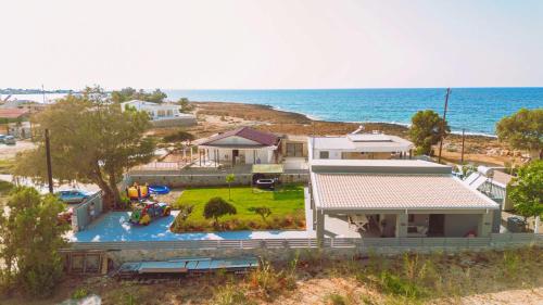 an aerial view of a house and the ocean at Blue Lagoon Villa in Stavros