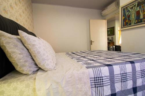 a bedroom with a bed with pillows on it at cozy and spacious Apartment in the heart of Yogyakarta in Kejayan