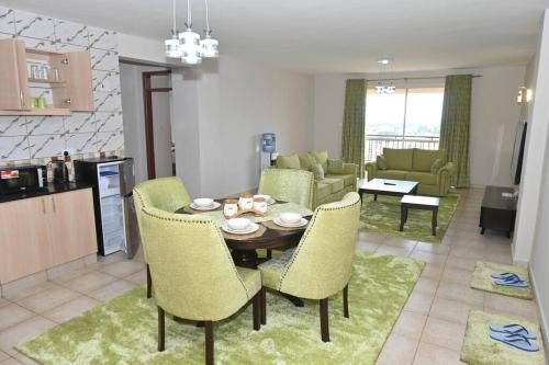 a kitchen and living room with a table and chairs at Lota Green 2BR in Nanyuki in Nanyuki