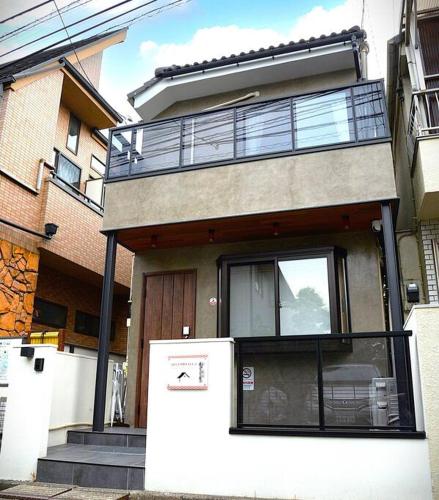 a house with a refrigerator in front of it at 高円寺中野Villa in Tokyo